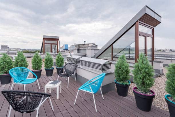 Rooftop terrace with modern chairs Beautiful rooftop terrace with stylish black and turquoise chairs Multifunctional Furnishings: Optimize Space on roof stock pictures, royalty-free photos & images.