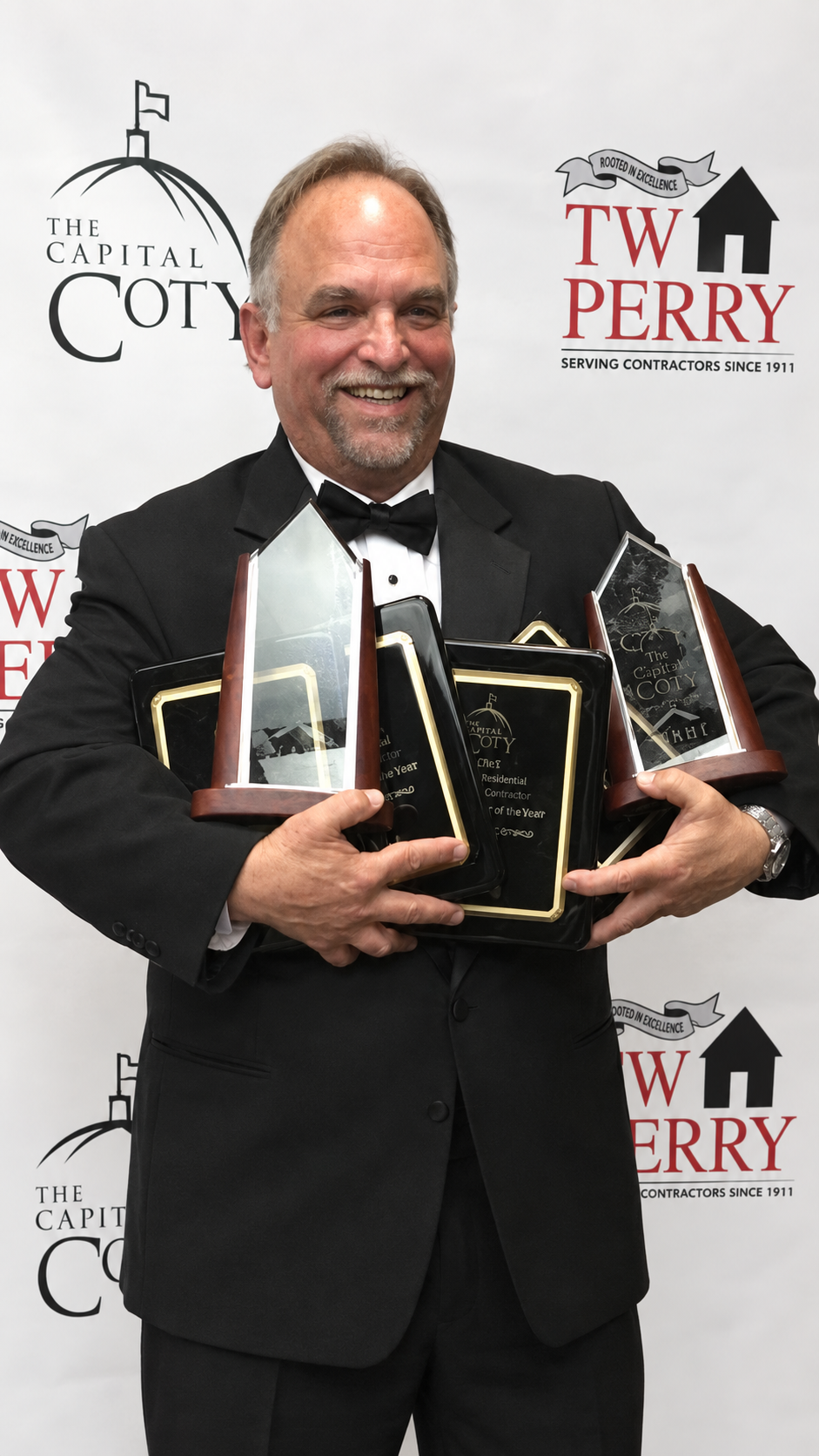 Bob Berriz holding Capital COTY and NARI Contractor of the Year awards